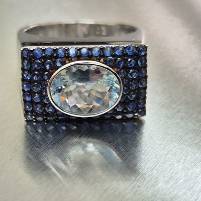 Lot 43 - An aquamarine and sapphire contemporary ring....