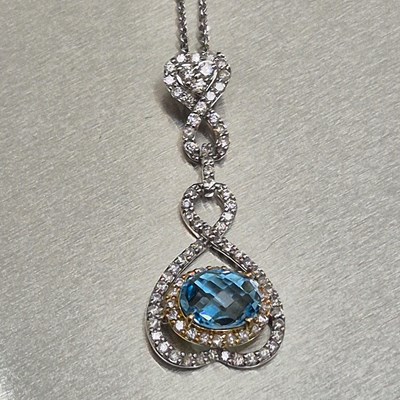 Lot 44 - A blue topaz and diamond articulating drop...