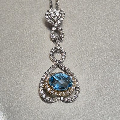 Lot 44 - A blue topaz and diamond articulating drop...