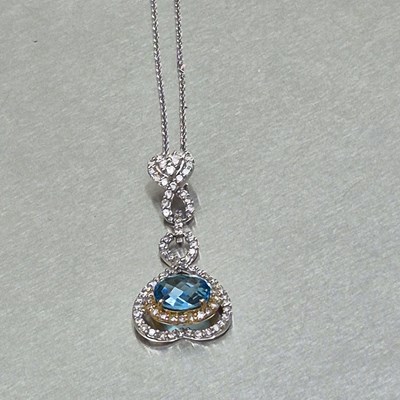 Lot 44 - A blue topaz and diamond articulating drop...