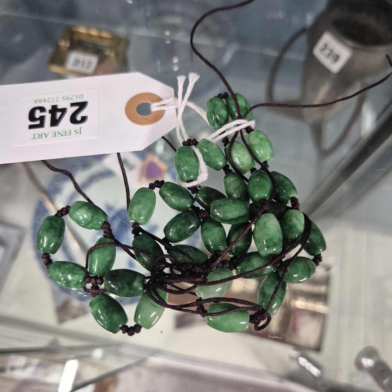 Lot 245 - A Chinese green stone (aventurine?) bead necklace