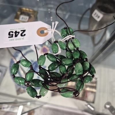 Lot 245 - A Chinese green stone (aventurine?) bead necklace