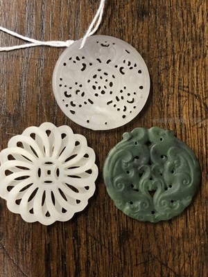 Lot 247 - Three Chinese pierced roundel pendants in jade...