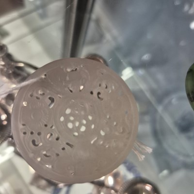 Lot 247 - Three Chinese pierced roundel pendants in jade...