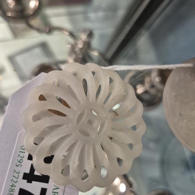 Lot 247 - Three Chinese pierced roundel pendants in jade...