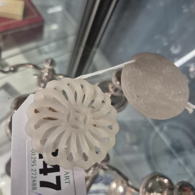 Lot 247 - Three Chinese pierced roundel pendants in jade...