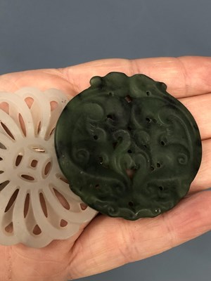 Lot 247 - Three Chinese pierced roundel pendants in jade...