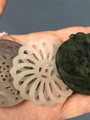 Lot 247 - Three Chinese pierced roundel pendants in jade...
