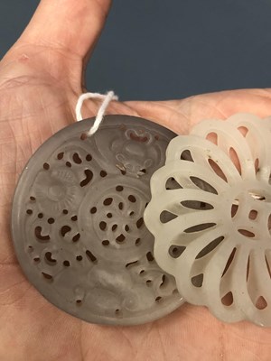 Lot 247 - Three Chinese pierced roundel pendants in jade...