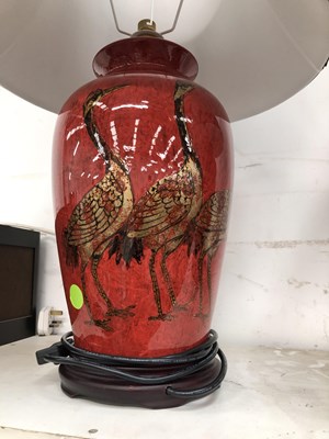 Lot 282 - A pair of red glazed table lamps.