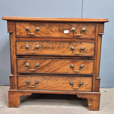 Lot 281 - A mahogany chest of four drawers between...