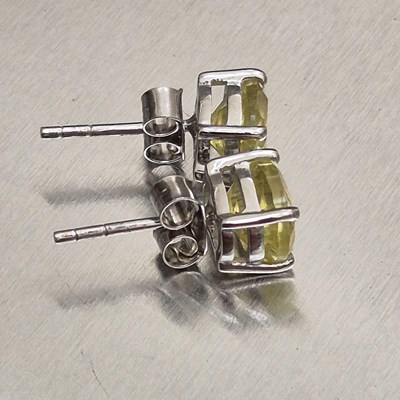 Lot 25 - A pair of lemon quartz stud earrings set in...