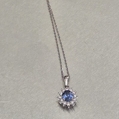 Lot 61 - A sapphire and diamond oval cluster pendant...