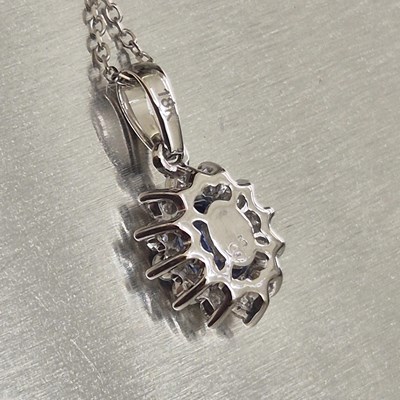 Lot 61 - A sapphire and diamond oval cluster pendant...