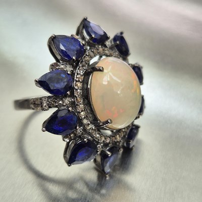 Lot 67 - A large cocktail cluster ring set with an oval...