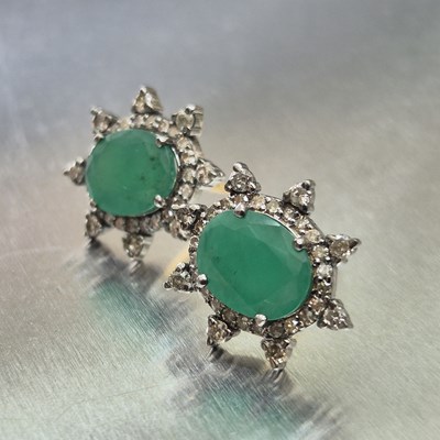 Lot 68 - A pair of oval emerald and diamond star...