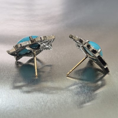 Lot 73 - A pair of oval cabochon turquoise and diamond...