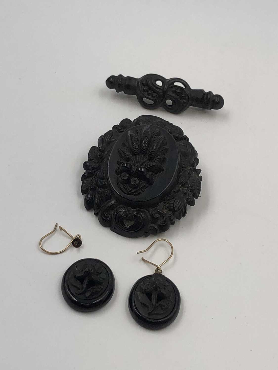 Lot 22 - Three pieces of carved mourning jewellery. A...