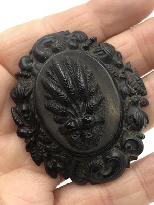 Lot 22 - Three pieces of carved mourning jewellery. A...