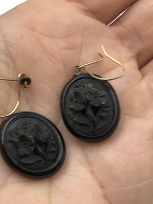 Lot 22 - Three pieces of carved mourning jewellery. A...