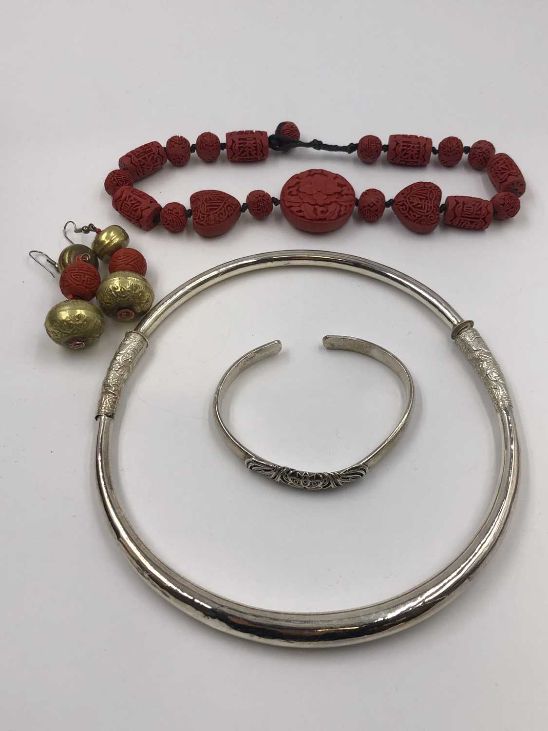 Lot 26 - A Chinese silver torque bangle, stamped 999, a...