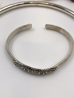 Lot 26 - A Chinese silver torque bangle, stamped 999, a...