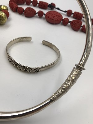 Lot 26 - A Chinese silver torque bangle, stamped 999, a...