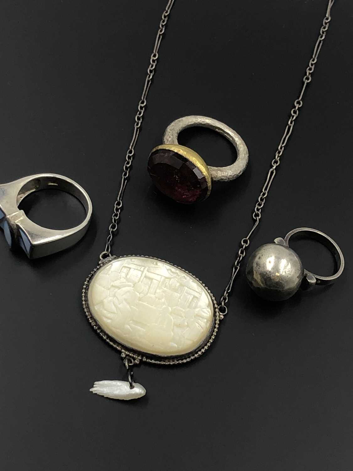 Lot 41 - A Chinese mother-of-pearl carved panel pendant...