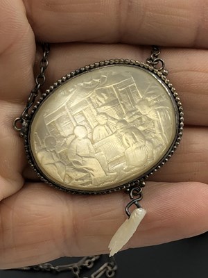 Lot 41 - A Chinese mother-of-pearl carved panel pendant...