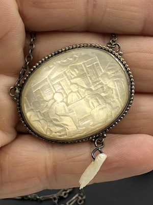 Lot 41 - A Chinese mother-of-pearl carved panel pendant...