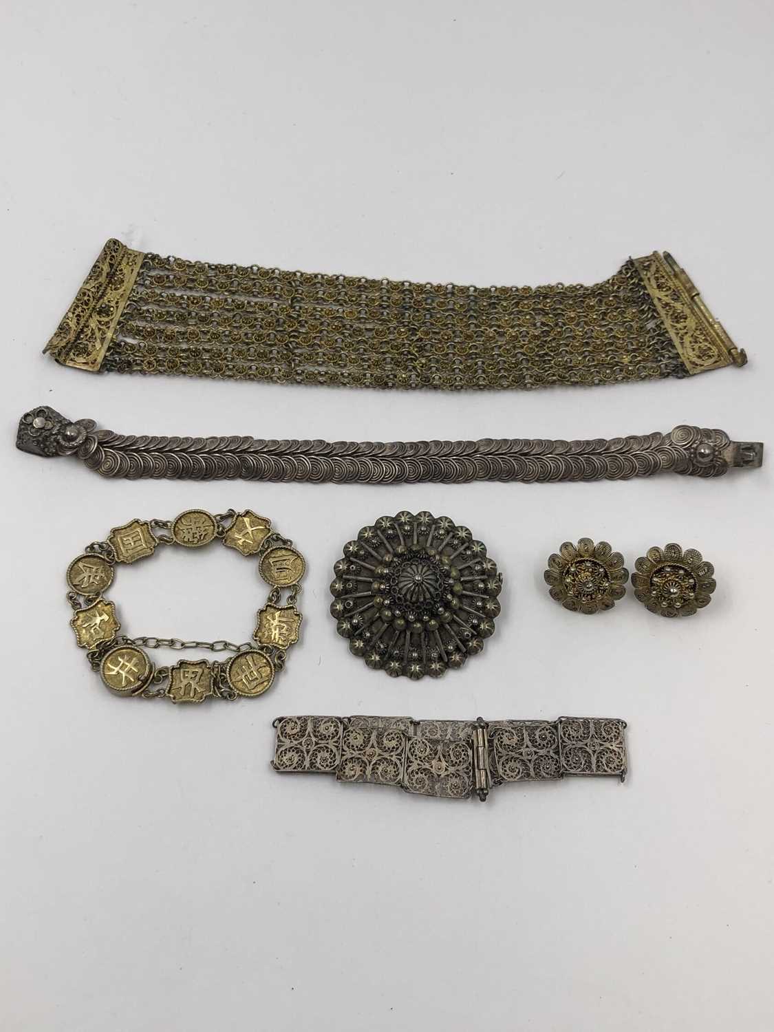 Lot 42 - A Chinese silver gilt character panel bracelet...