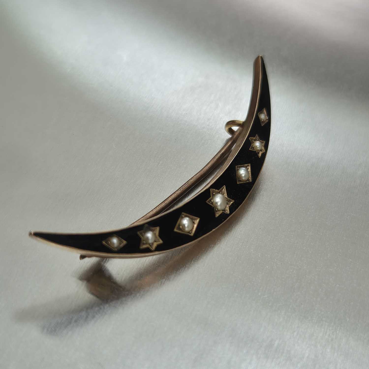 Lot 76 - An antique seed pearl and black enamel...