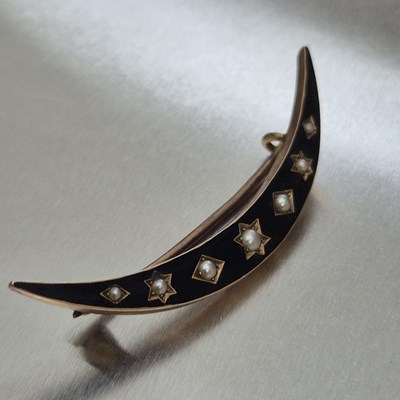 Lot 76 - An antique seed pearl and black enamel...