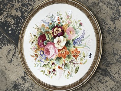 Lot 560 - A pair of flower painted pottery circular wall...