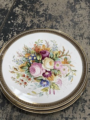 Lot 560 - A pair of flower painted pottery circular wall...