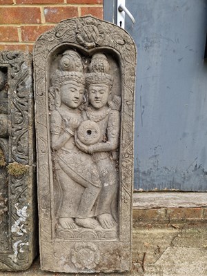 Lot 701 - An Eastern relief decorated temple panel.