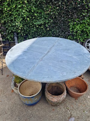 Lot 711 - A large circular zinc-topped patio table.