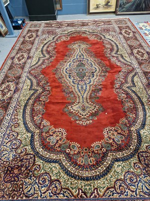 Lot 641 - A machine made carpet of Persian design. 480 x...