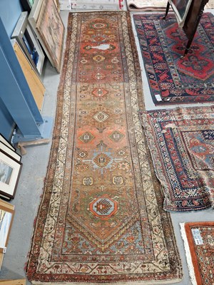 Lot 647 - An antique Persian tribal runner. 350 x 93cms