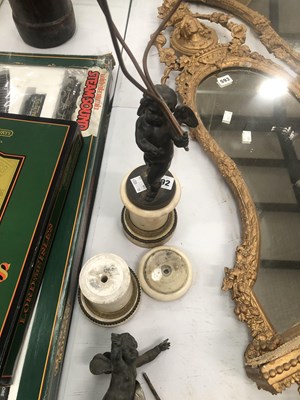 Lot 592 - A three light table lamp supported by a Cupid...