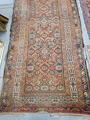 Lot 655 - An antique Persian tribal runner. 300 x 100cms
