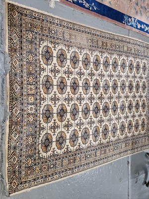 Lot 657 - A machine made rug of Bokhara design