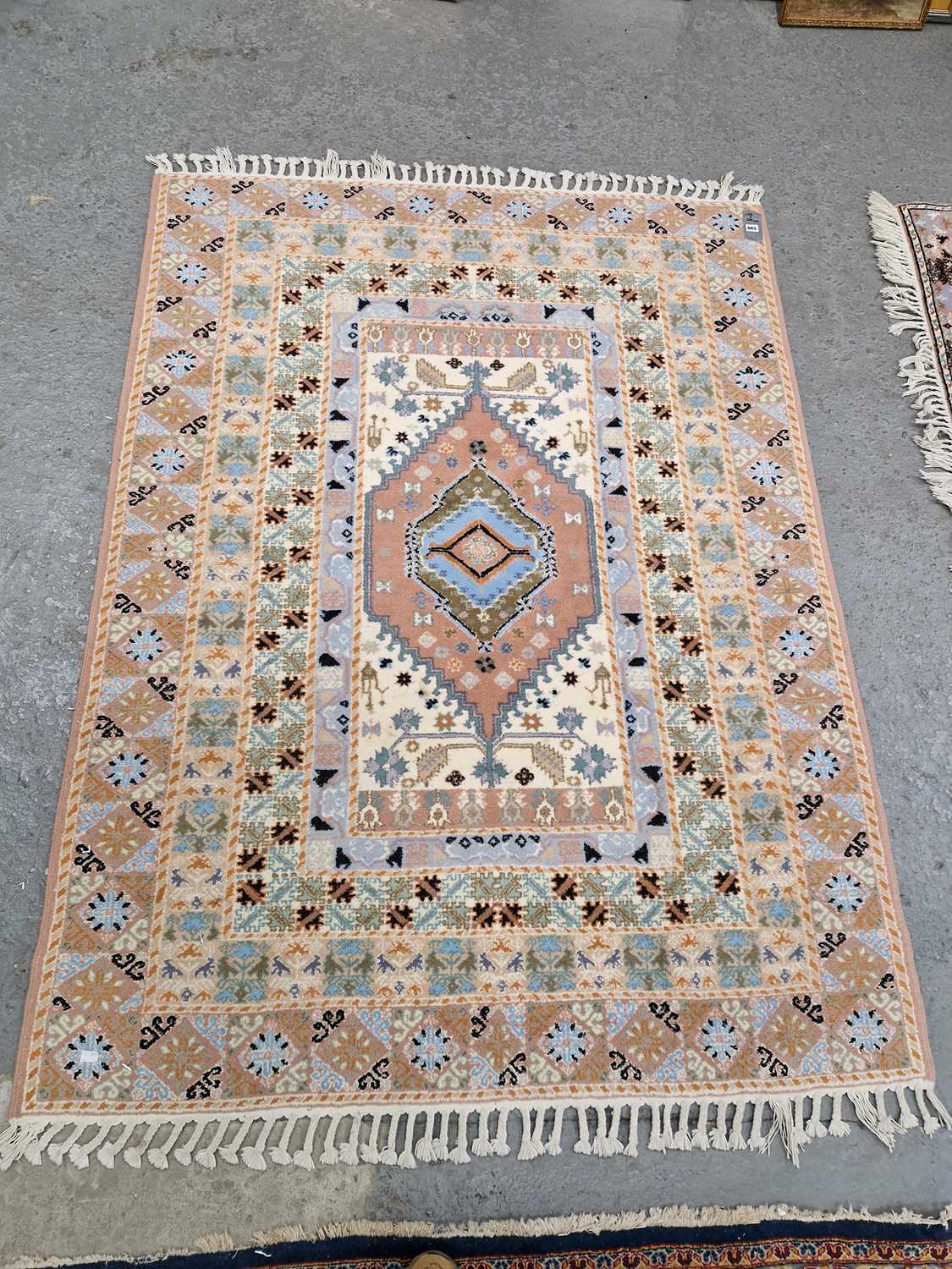 Lot 665 - An Oriental rug of tribal design