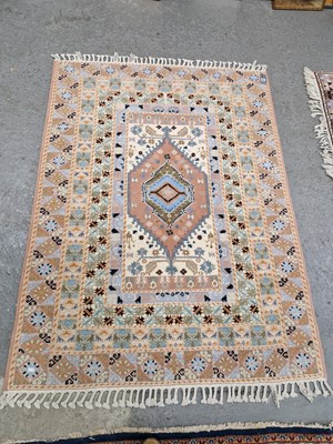 Lot 665 - An Oriental rug of tribal design