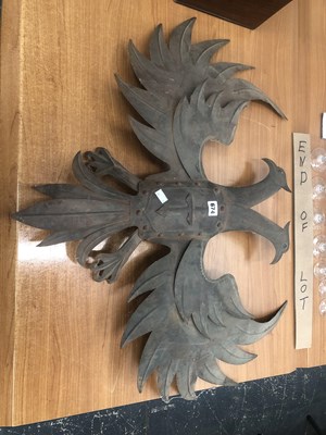 Lot 674 - A sheet iron spreadeagle backed by a light socket