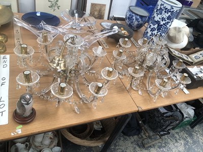 Lot 679 - A pair of six light glass chandeliers, the...