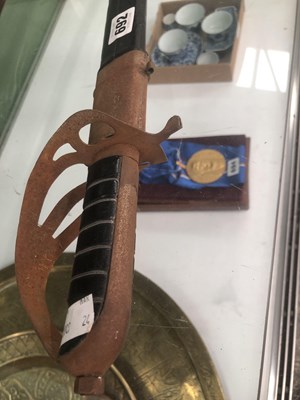 Lot 692 - A sabre in a leather scabbard, the blade etched