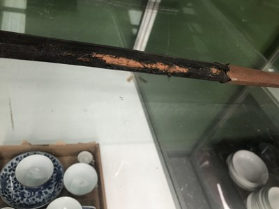Lot 692 - A sabre in a leather scabbard, the blade etched