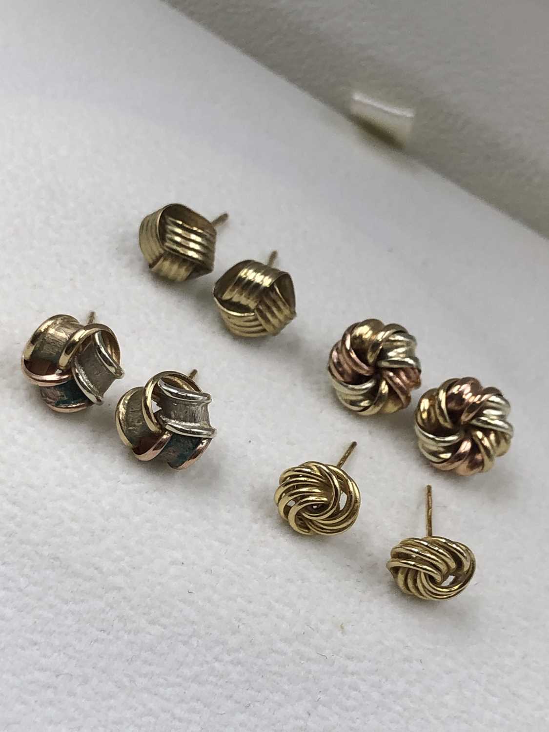 Lot 69 - Four pairs of 9ct gold knot earrings of...