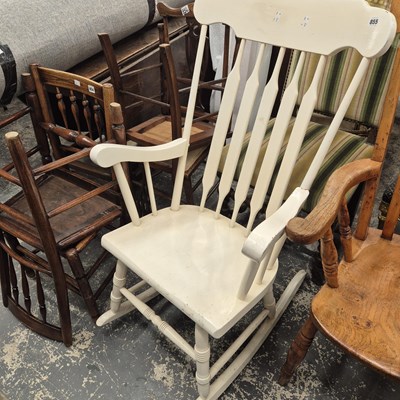 Lot 855 - A white painted rocking chair.